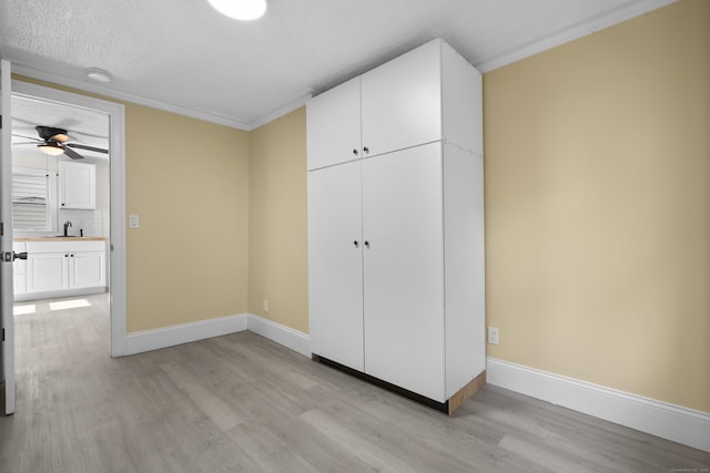 237 Helen St, Bridgeport, CT 06608 - unfurnished bedroom featuring light wood-style flooring, a closet, and a textured ceiling
