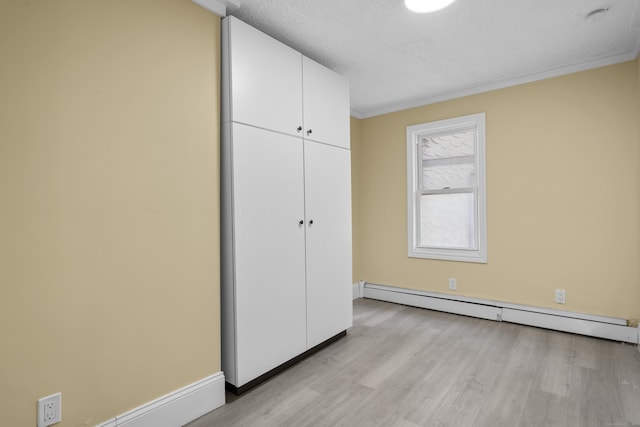 237 Helen St, Bridgeport, CT 06608 - unfurnished bedroom featuring a baseboard radiator, light wood finished floors, crown molding, and a closet