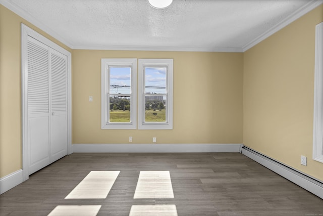 237 Helen St, Bridgeport, CT 06608 - unfurnished bedroom with baseboard heating, wood finished floors, a textured ceiling, crown molding, and a closet