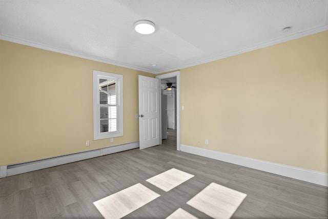 237 Helen St, Bridgeport, CT 06608 - empty room featuring a baseboard heating unit, wood finished floors, ornamental molding, and a ceiling fan