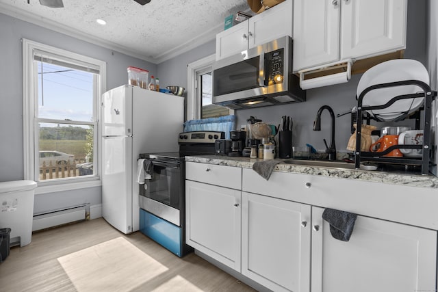 237 Helen St, Bridgeport, CT 06608 - kitchen featuring stainless steel appliances, baseboard heating, light wood finished floors, white cabinets, and a textured ceiling