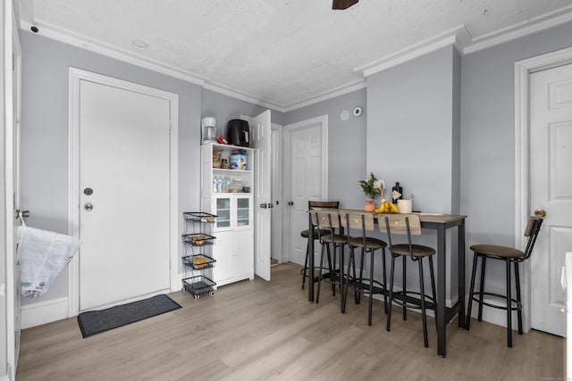 237 Helen St, Bridgeport, CT 06608 - dining area with wood finished floors, a textured ceiling, and ornamental molding