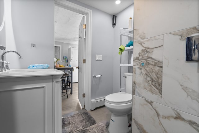 237 Helen St, Bridgeport, CT 06608 - bathroom featuring a baseboard radiator, vanity, and a textured ceiling