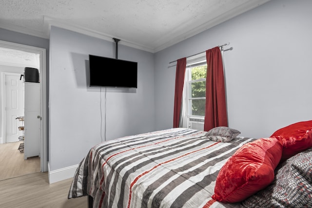 237 Helen St, Bridgeport, CT 06608 - bedroom featuring wood finished floors, a textured ceiling, and ornamental molding