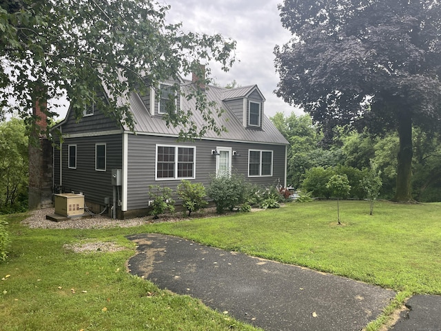 57 S Main St, East Granby, CT 06026 - cape cod home with a metal roof, a front lawn, and a chimney