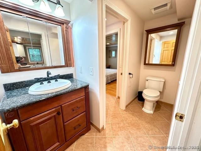 57 S Main St, East Granby, CT 06026 - ensuite bathroom with vanity and tile patterned flooring