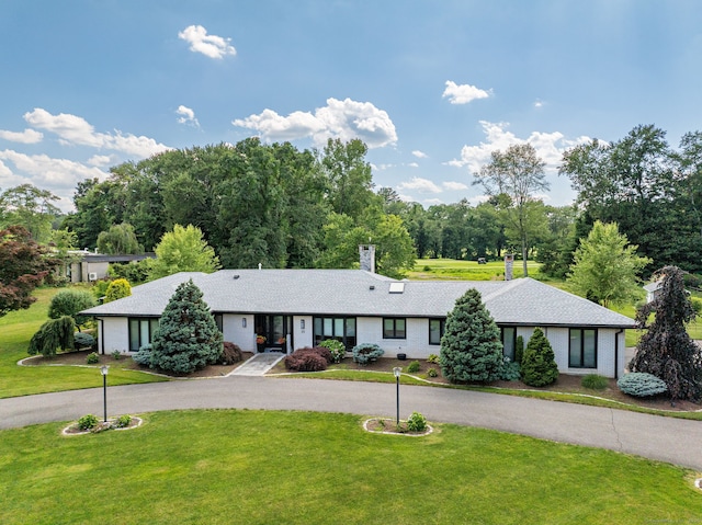 10 Prynne Ridge Rd, Longmeadow, MA 01106 - view of front of property featuring a front yard, a chimney, brick siding, and curved driveway