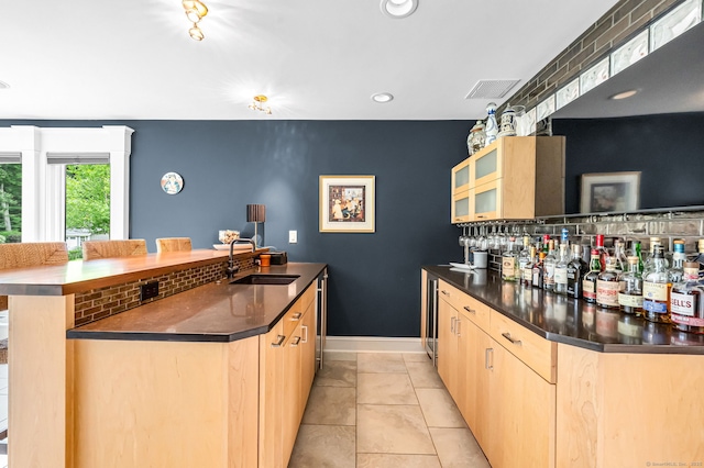 10 Prynne Ridge Rd, Longmeadow, MA 01106 - kitchen with light brown cabinets, dark countertops, glass insert cabinets, recessed lighting, and light tile patterned floors