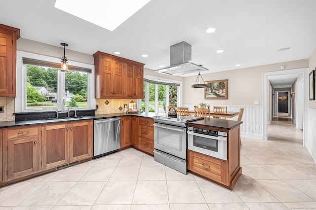10 Prynne Ridge Rd, Longmeadow, MA 01106 - kitchen featuring stainless steel appliances, island range hood, brown cabinetry, tasteful backsplash, and recessed lighting
