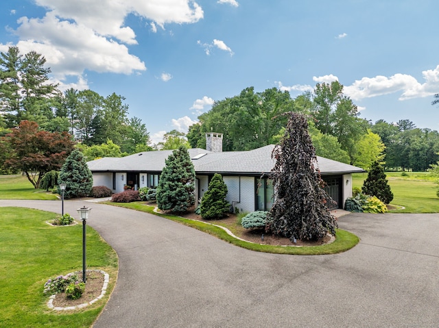 10 Prynne Ridge Rd, Longmeadow, MA 01106 - view of front of property with curved driveway, a front lawn, a chimney, and an attached garage