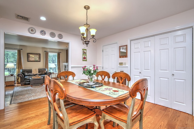 11 Sweetbriar Ln, Newtown, CT 06482 - dining space with light wood-type flooring, a chandelier, and a wainscoted wall