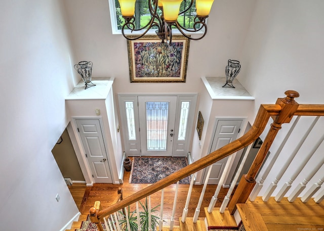 11 Sweetbriar Ln, Newtown, CT 06482 - foyer featuring wood finished floors, a towering ceiling, stairway, and a chandelier