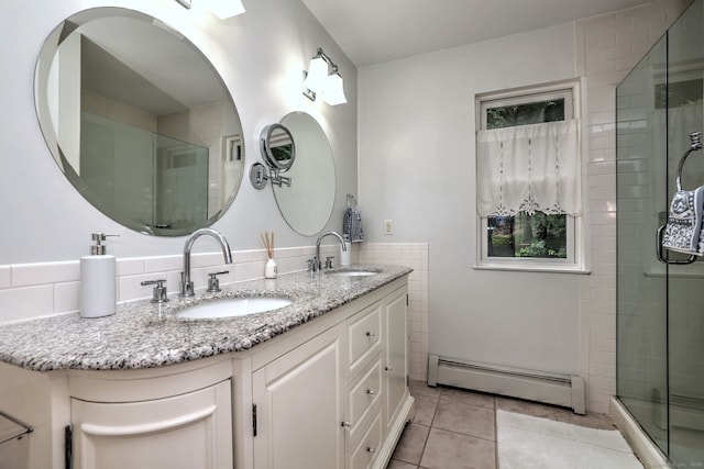 11 Sweetbriar Ln, Newtown, CT 06482 - bathroom with a baseboard heating unit, double vanity, a stall shower, tile patterned flooring, and tile walls