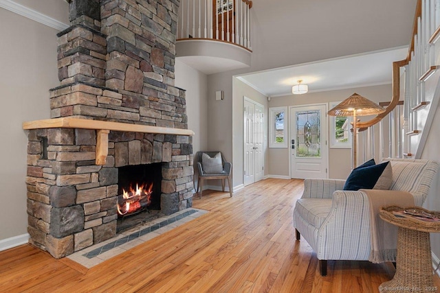 6 Tonetta Cir, Norwalk, CT 06855 - living area with ornamental molding, wood finished floors, a fireplace, and stairs