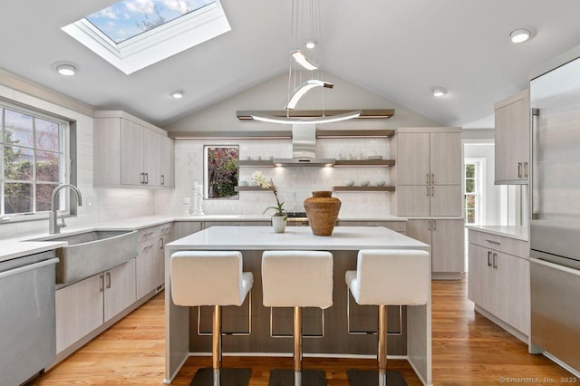 6 Tonetta Cir, Norwalk, CT 06855 - kitchen with appliances with stainless steel finishes, island exhaust hood, lofted ceiling, open shelves, and a skylight