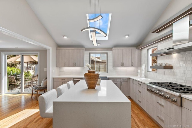 6 Tonetta Cir, Norwalk, CT 06855 - kitchen with stainless steel gas stovetop, lofted ceiling, wall chimney range hood, light countertops, and decorative backsplash