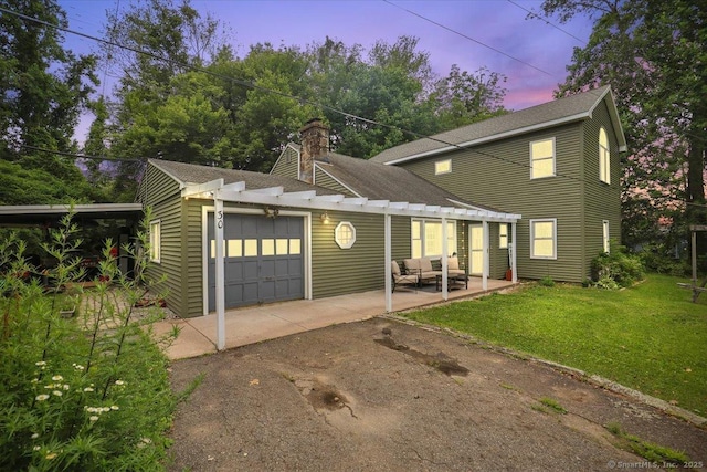30 Lake Rd, Columbia, CT 06237 - view of front of property featuring asphalt driveway, a garage, a lawn, a pergola, and a chimney