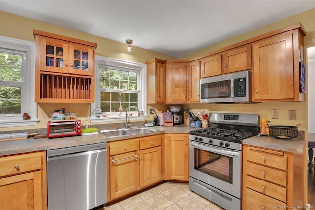30 Lake Rd, Columbia, CT 06237 - kitchen with appliances with stainless steel finishes, light tile patterned floors, glass insert cabinets, and light countertops