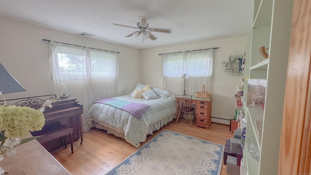 70 River Rd, Preston, CT 06365 - bedroom featuring wood finished floors, a ceiling fan, and baseboard heating