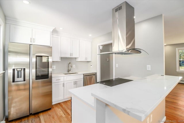 18 Greenbrier Rd, East Hartford, CT 06118 - kitchen featuring appliances with stainless steel finishes, island range hood, a peninsula, white cabinetry, and light wood-type flooring