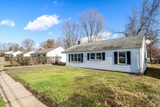 18 Greenbrier Rd, East Hartford, CT 06118 - view of side of property featuring a chimney, a lawn, and roof with shingles