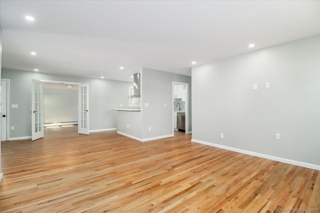 18 Greenbrier Rd, East Hartford, CT 06118 - unfurnished living room with french doors, light wood-style floors, and recessed lighting