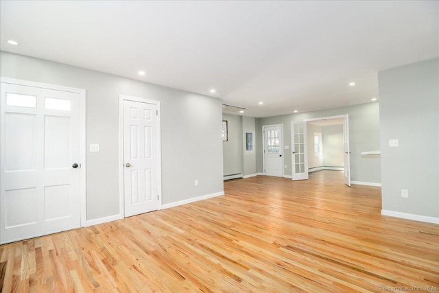 18 Greenbrier Rd, East Hartford, CT 06118 - unfurnished living room featuring a baseboard radiator, light wood-style floors, recessed lighting, and baseboard heating