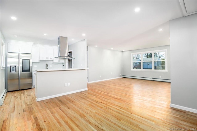 18 Greenbrier Rd, East Hartford, CT 06118 - kitchen with stainless steel refrigerator with ice dispenser, a baseboard radiator, exhaust hood, white cabinets, and light wood-style floors