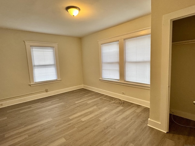 393 Newhall St, New Haven, CT 06511 - unfurnished bedroom featuring wood finished floors and a closet