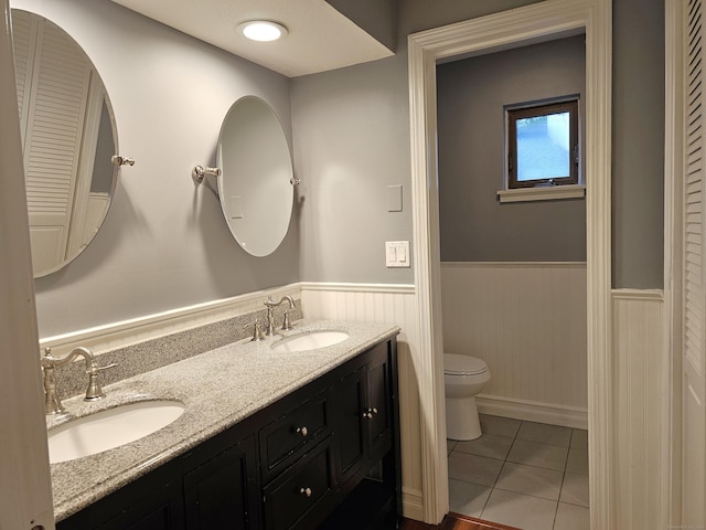 29 Great Meadow Ln Unit 29, Farmington, CT 06001 - full bathroom with double vanity, a wainscoted wall, tile patterned floors, and a closet