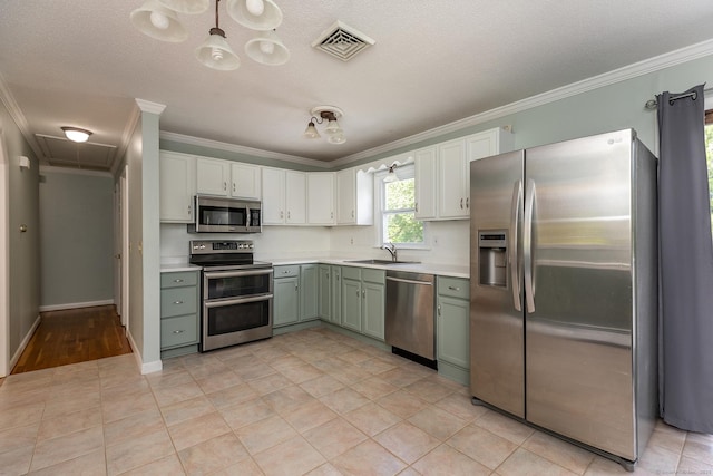 21 Brentwood Rd, New Milford, CT 06776 - kitchen featuring stainless steel appliances, crown molding, light countertops, green cabinetry, and white cabinets