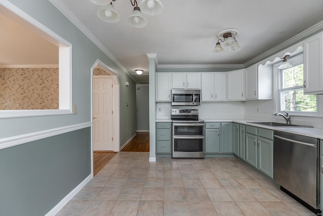 21 Brentwood Rd, New Milford, CT 06776 - kitchen with appliances with stainless steel finishes, light countertops, white cabinetry, ornamental molding, and a chandelier
