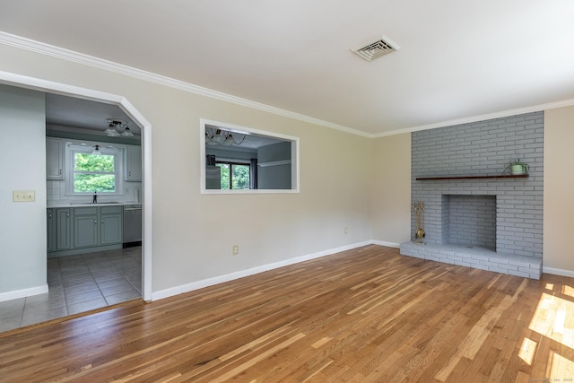 21 Brentwood Rd, New Milford, CT 06776 - unfurnished living room with light wood-type flooring, plenty of natural light, a fireplace, and ornamental molding