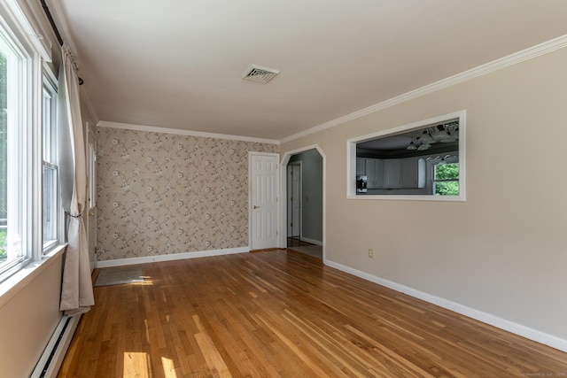 21 Brentwood Rd, New Milford, CT 06776 - empty room featuring a baseboard radiator, wood finished floors, crown molding, and arched walkways