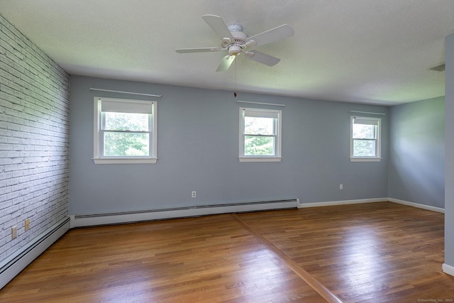 21 Brentwood Rd, New Milford, CT 06776 - empty room with baseboard heating, wood finished floors, ceiling fan, and brick wall