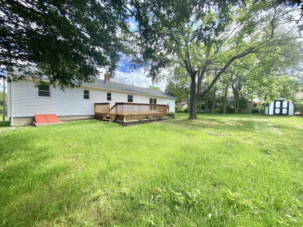 475 Oceanview Ter, Stratford, CT 06614 - view of green lawn featuring a shed and a wooden deck