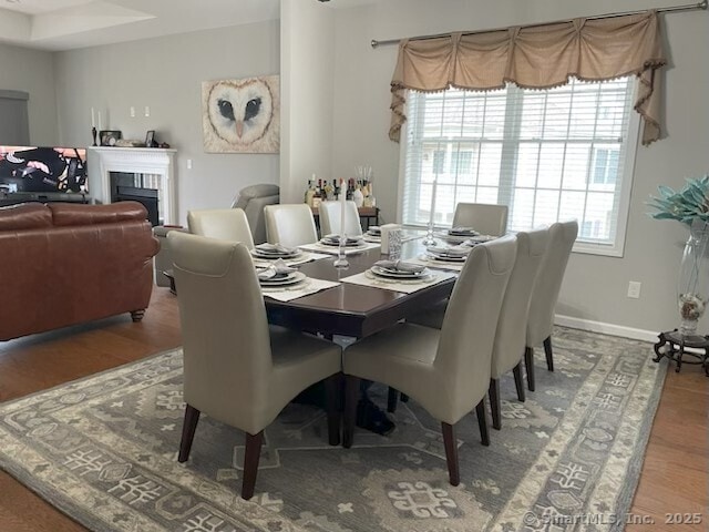 36 Todd St Unit 507, Hamden, CT 06518 - dining space featuring wood finished floors and a fireplace
