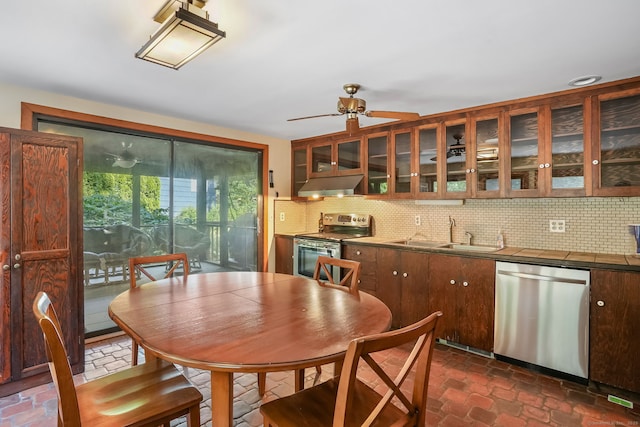 12 Sage Rd, Danbury, CT 06810 - kitchen with stainless steel appliances, under cabinet range hood, tasteful backsplash, and tile counters