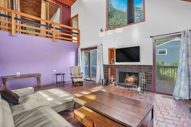 12 Sage Rd, Danbury, CT 06810 - living room featuring a tile fireplace, a towering ceiling, and brick flooring