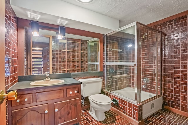 12 Sage Rd, Danbury, CT 06810 - full bath featuring bath / shower combo with glass door, vanity, tile walls, and a textured ceiling