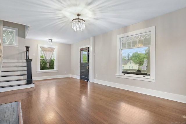 79 W Wooster St, Danbury, CT 06810 - unfurnished living room with wood finished floors, stairs, and a chandelier