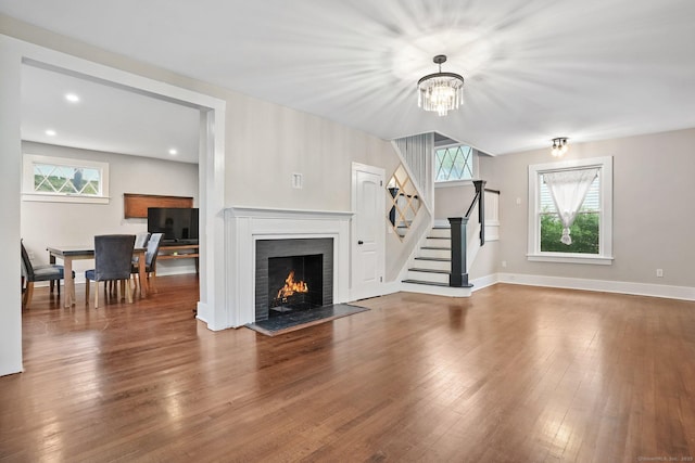 79 W Wooster St, Danbury, CT 06810 - unfurnished living room with stairway, wood finished floors, a chandelier, a fireplace, and recessed lighting
