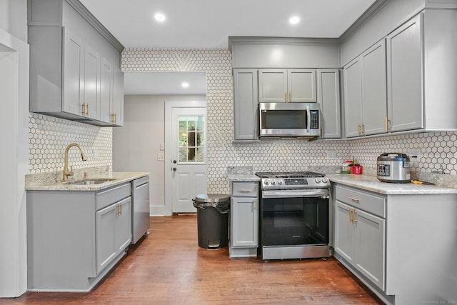79 W Wooster St, Danbury, CT 06810 - kitchen with appliances with stainless steel finishes, gray cabinets, backsplash, and wood finished floors
