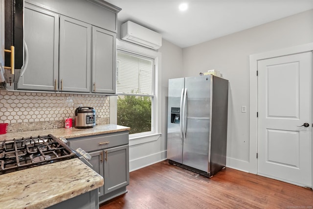 79 W Wooster St, Danbury, CT 06810 - kitchen featuring stainless steel refrigerator with ice dispenser, a wall mounted AC, gray cabinetry, dark wood-style flooring, and decorative backsplash