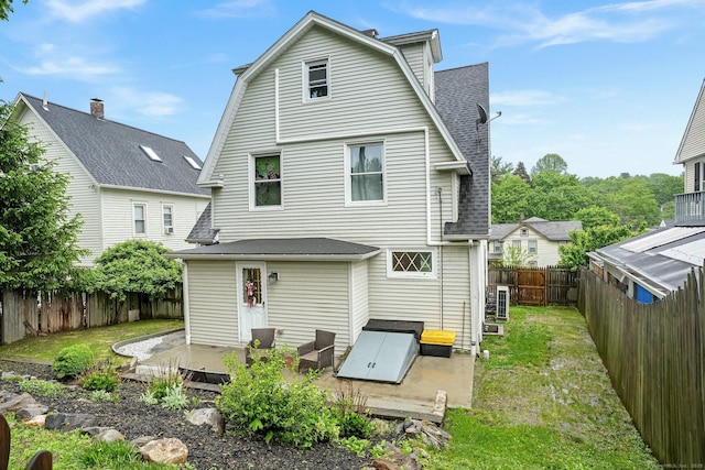79 W Wooster St, Danbury, CT 06810 - back of property featuring a patio, roof with shingles, a fenced backyard, and a gambrel roof
