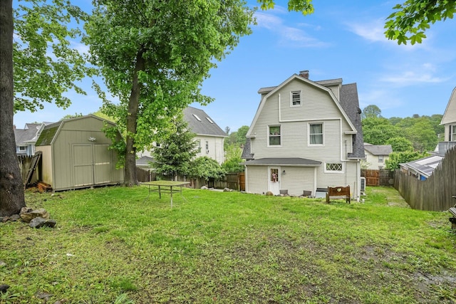 79 W Wooster St, Danbury, CT 06810 - rear view of house featuring a gambrel roof, a shed, a chimney, and a fenced backyard
