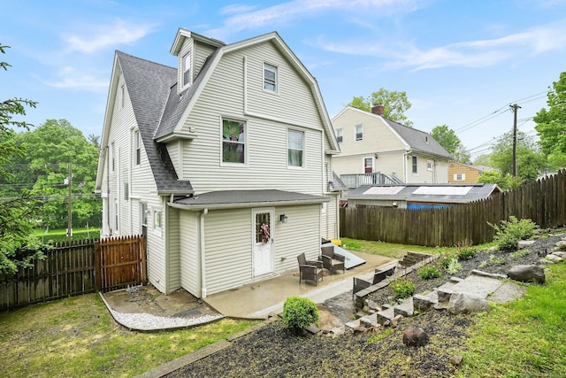 79 W Wooster St, Danbury, CT 06810 - rear view of property with a patio, roof with shingles, and a fenced backyard