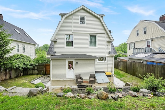 79 W Wooster St, Danbury, CT 06810 - back of house featuring a patio, a gambrel roof, and a fenced backyard