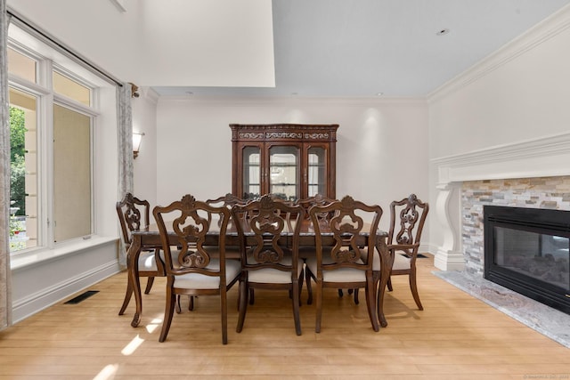 274 Sharon Tpke, Goshen, CT 06756 - dining room featuring light wood-style floors, crown molding, and a stone fireplace