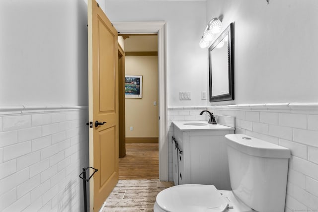 274 Sharon Tpke, Goshen, CT 06756 - half bathroom with tile walls, a wainscoted wall, vanity, and wood finished floors